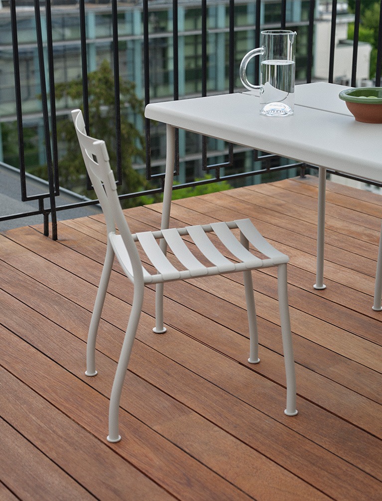 White metal outdoor Flaner chair and table on a terrace
