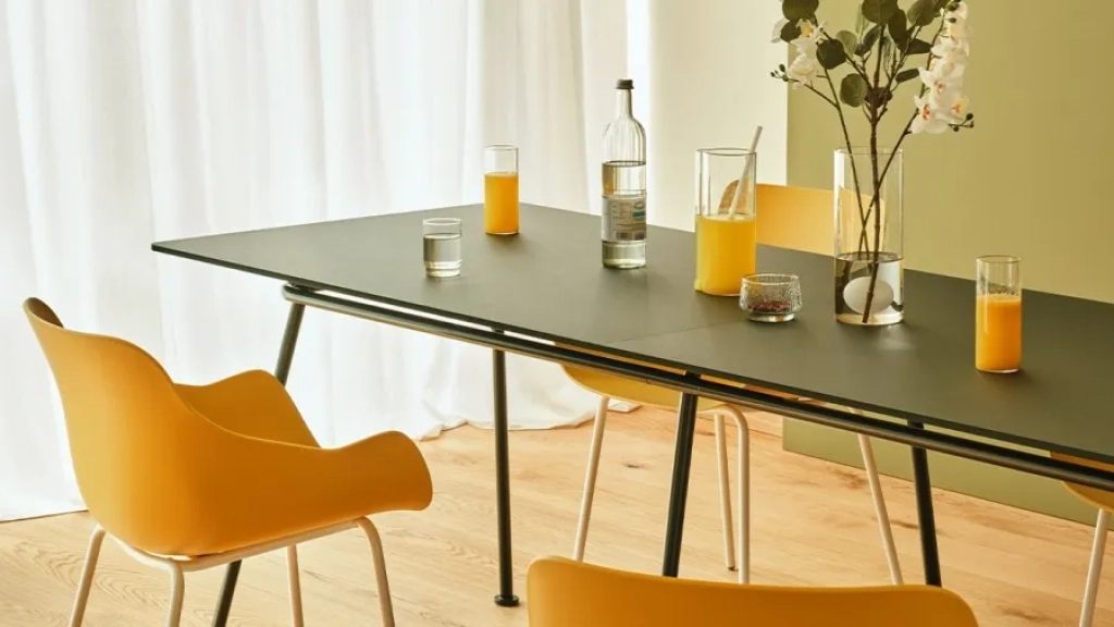 Green conference table on a curved tube base
