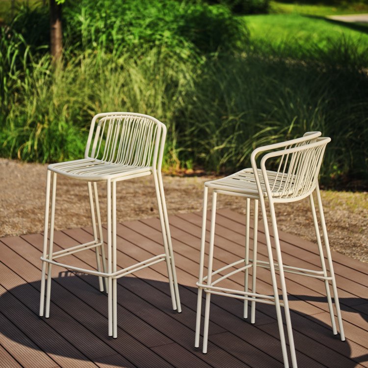 Stacked white Bris bar stools on a wooden terrace