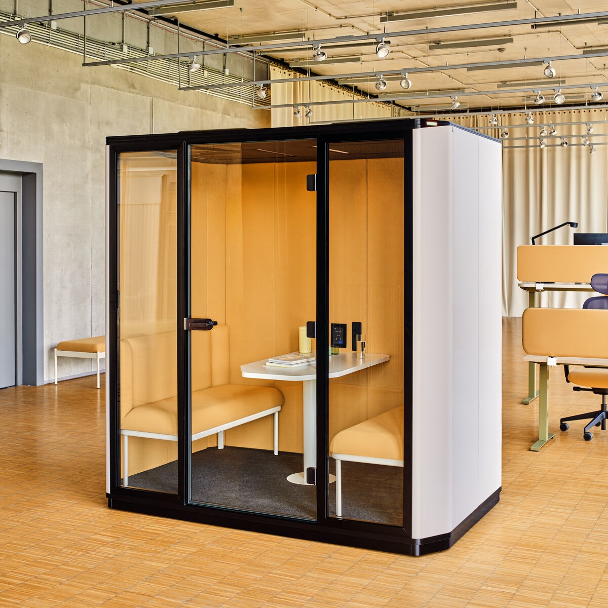 Acoustic booth with yellow upholstered interior