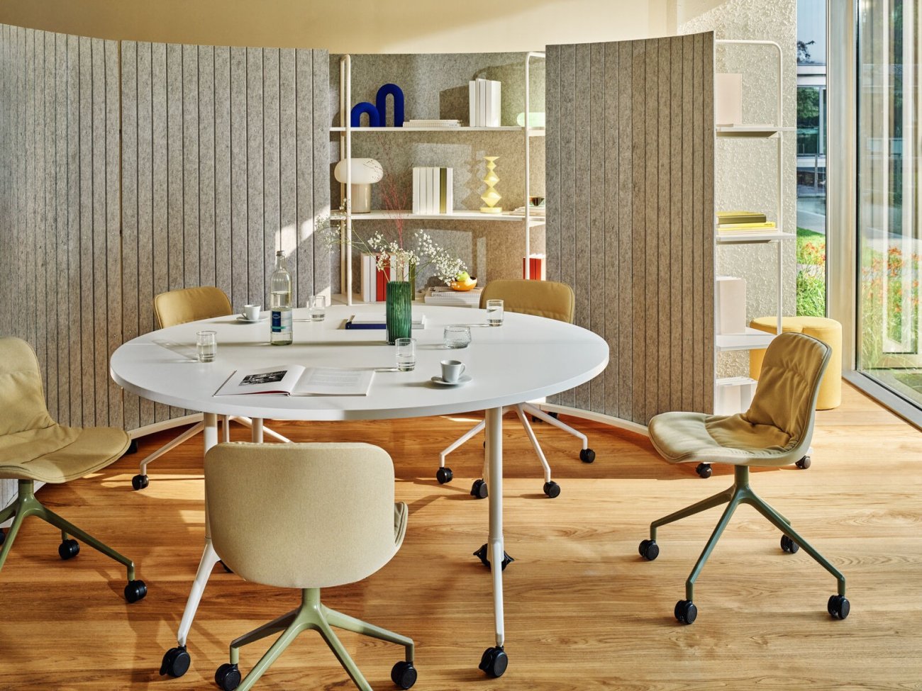 Krzesła na kółkach z drapowaną tapicerką, ustawione w przestrzeni spotkań