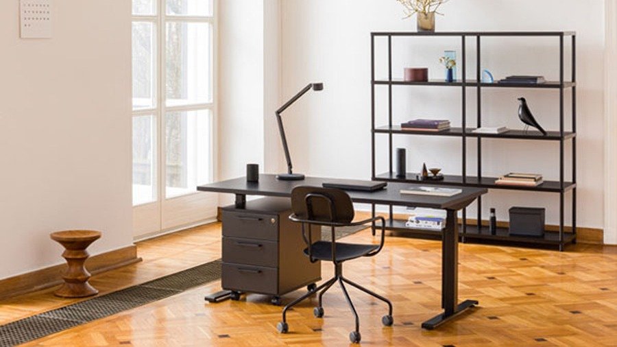 Mobile office drawer unit on wheels with three drawers under a black desk