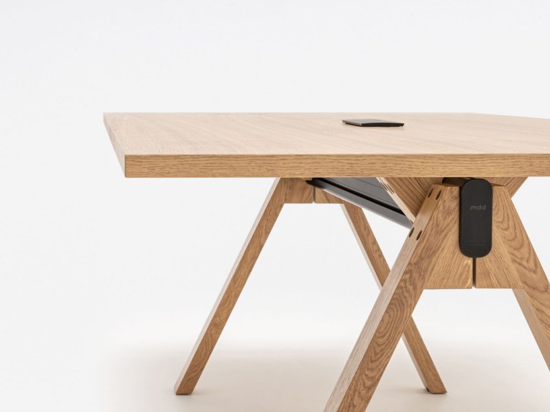 Modern Viga desk with solid wooden top and aluminium details, in an office setting