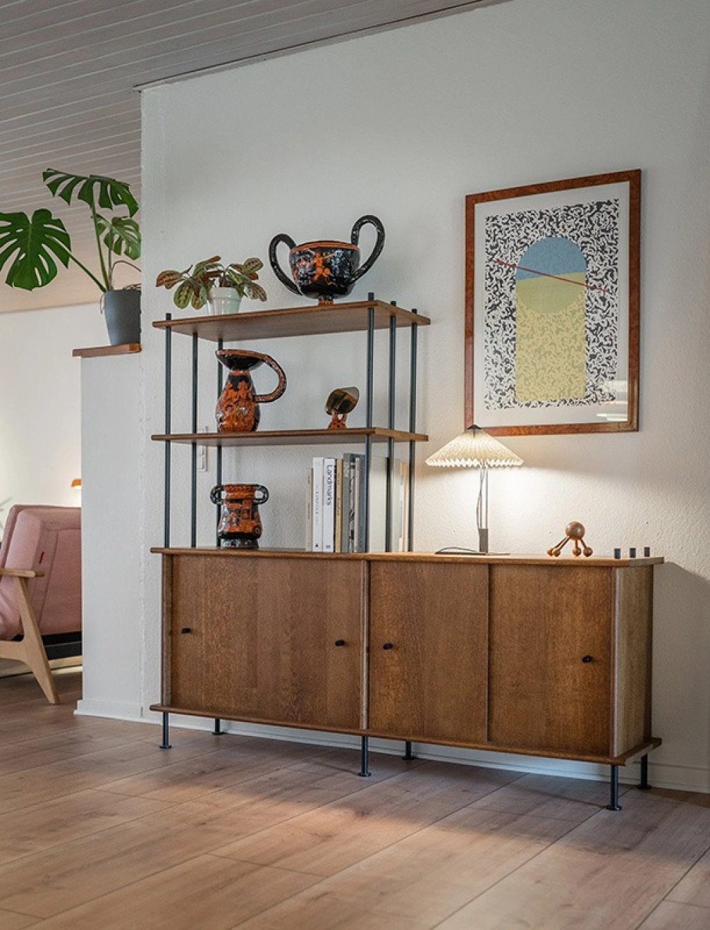 Wooden modular shelving unit with a metal frame and a lockable cabinet at the bottom