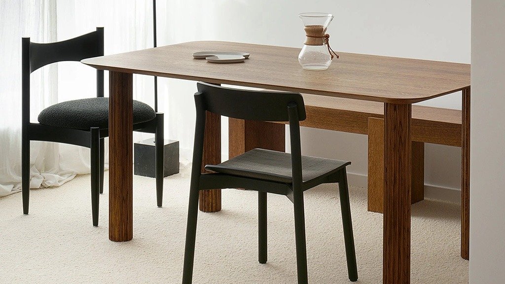 A rectangular wooden table with straight legs, paired with chairs